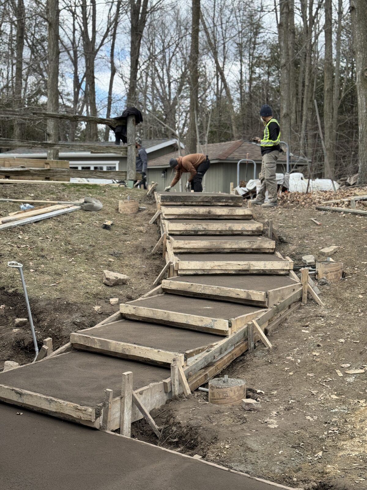 Freshly poured concrete steps and landing with wooden forms