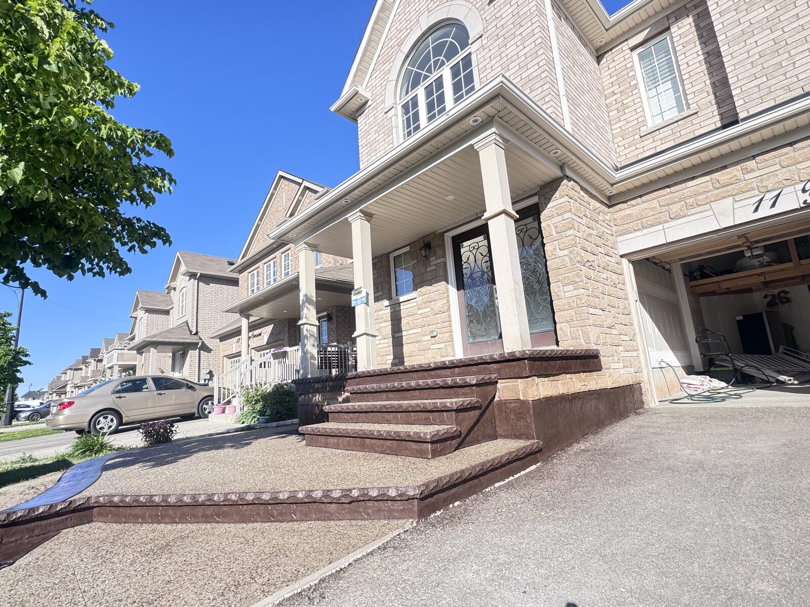 Exposed aggregate steps with stamped colored borders at a house