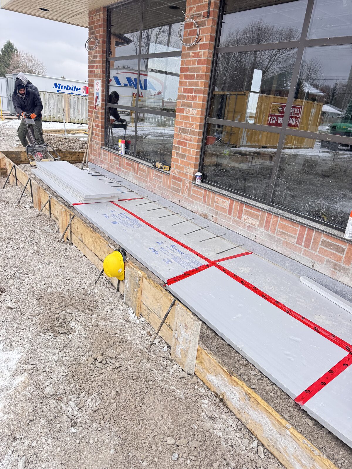 Concrete forms are being prepared for a new foundation pour.