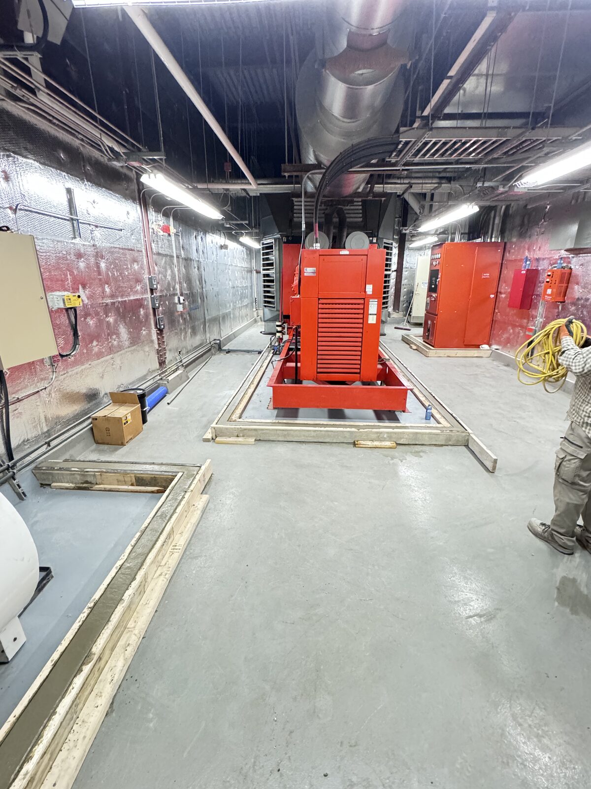 New concrete foundation being poured for equipment installation