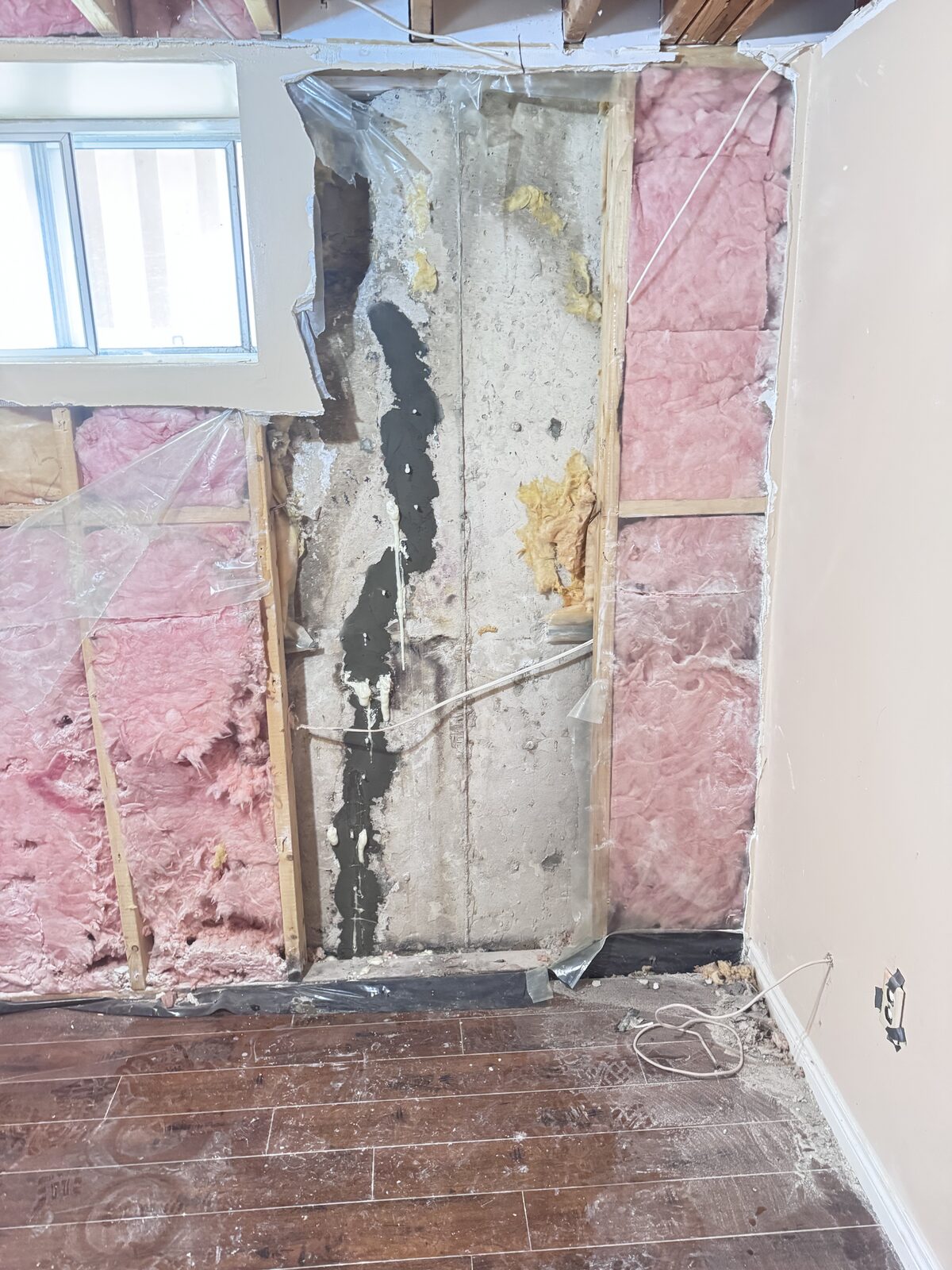 Concrete foundation wall with crack repair and insulation installation.