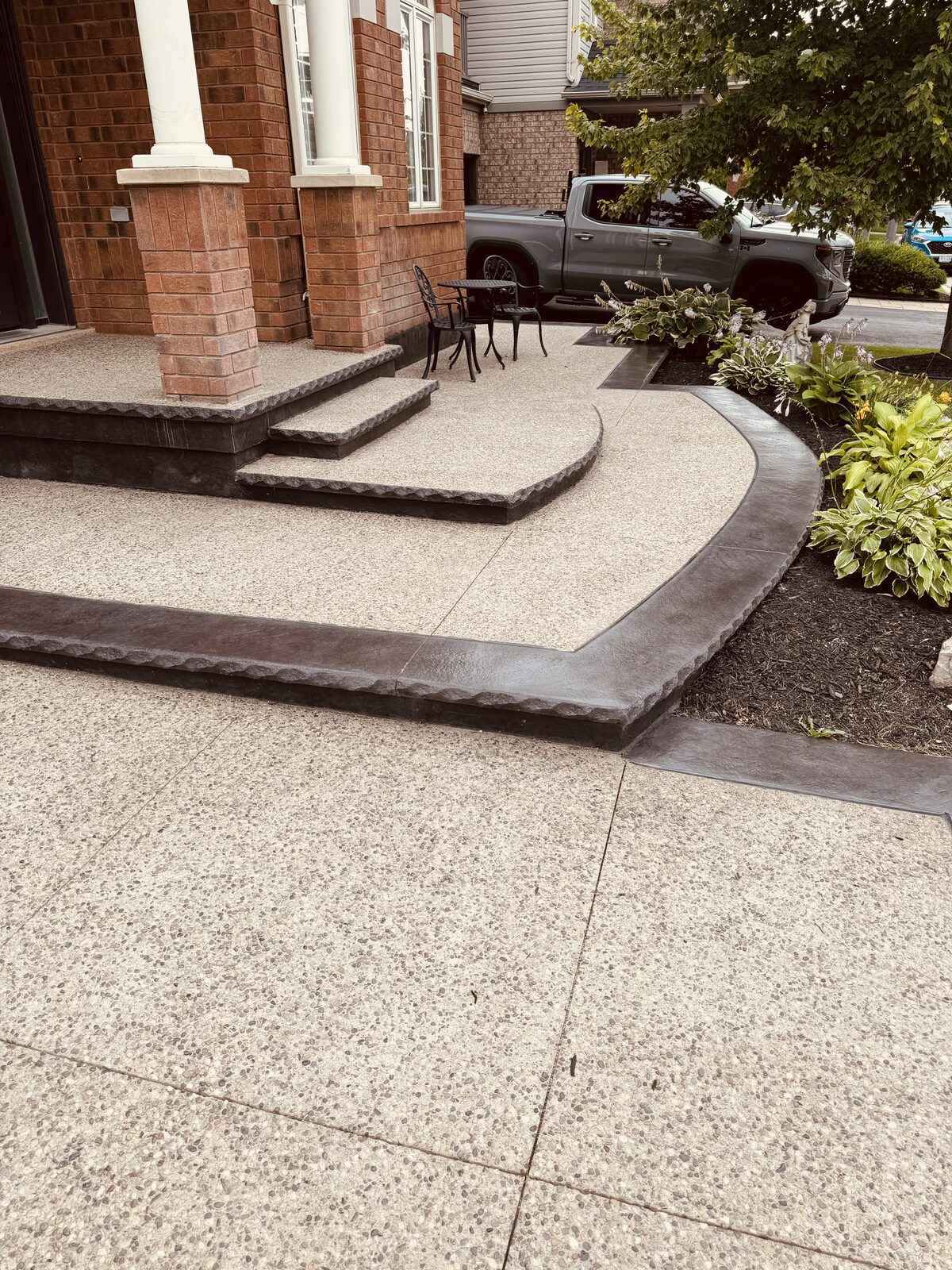 Exposed aggregate walkway and steps with stamped border.