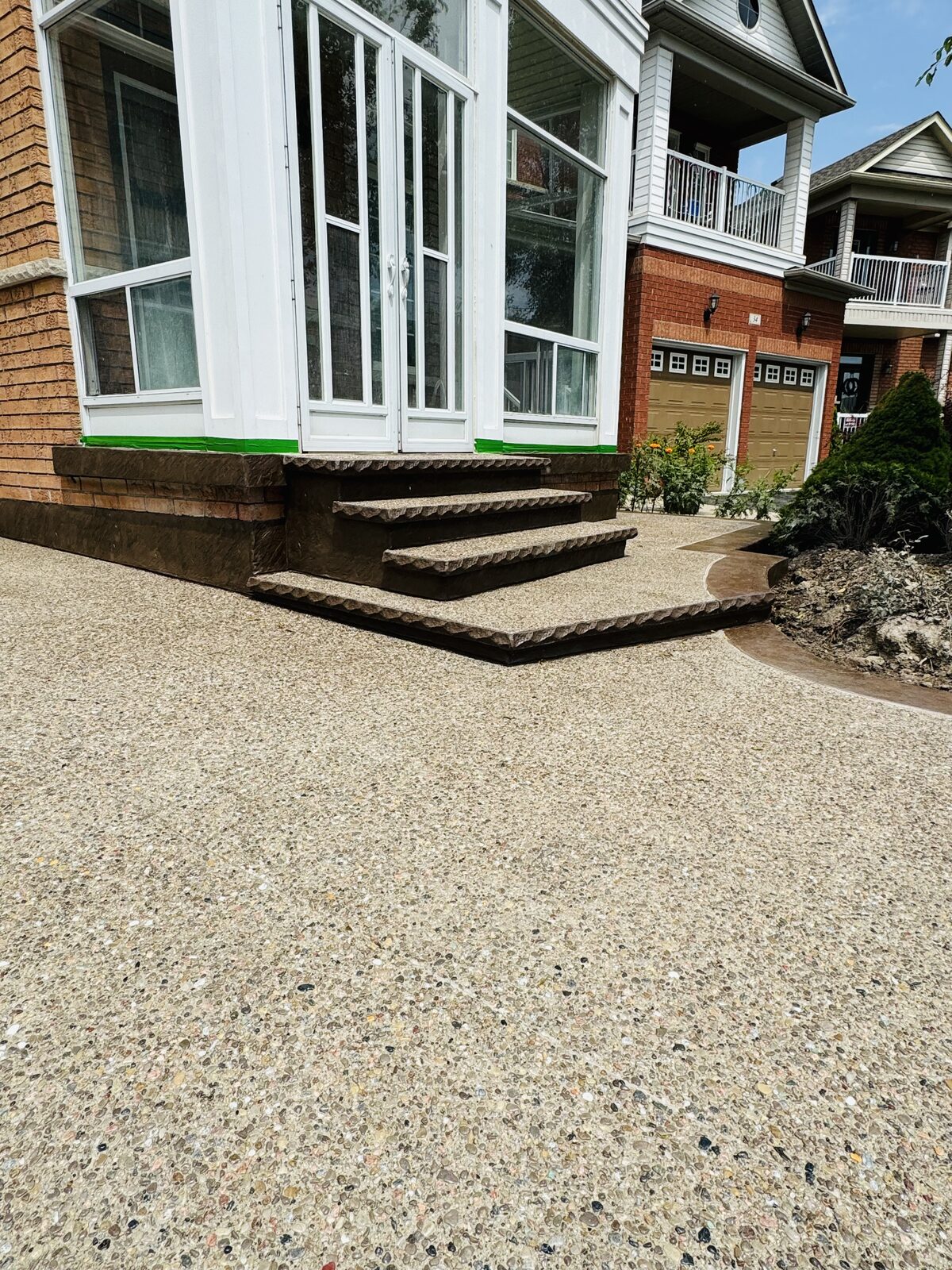 Exposed aggregate walkway and steps with stamped concrete accents