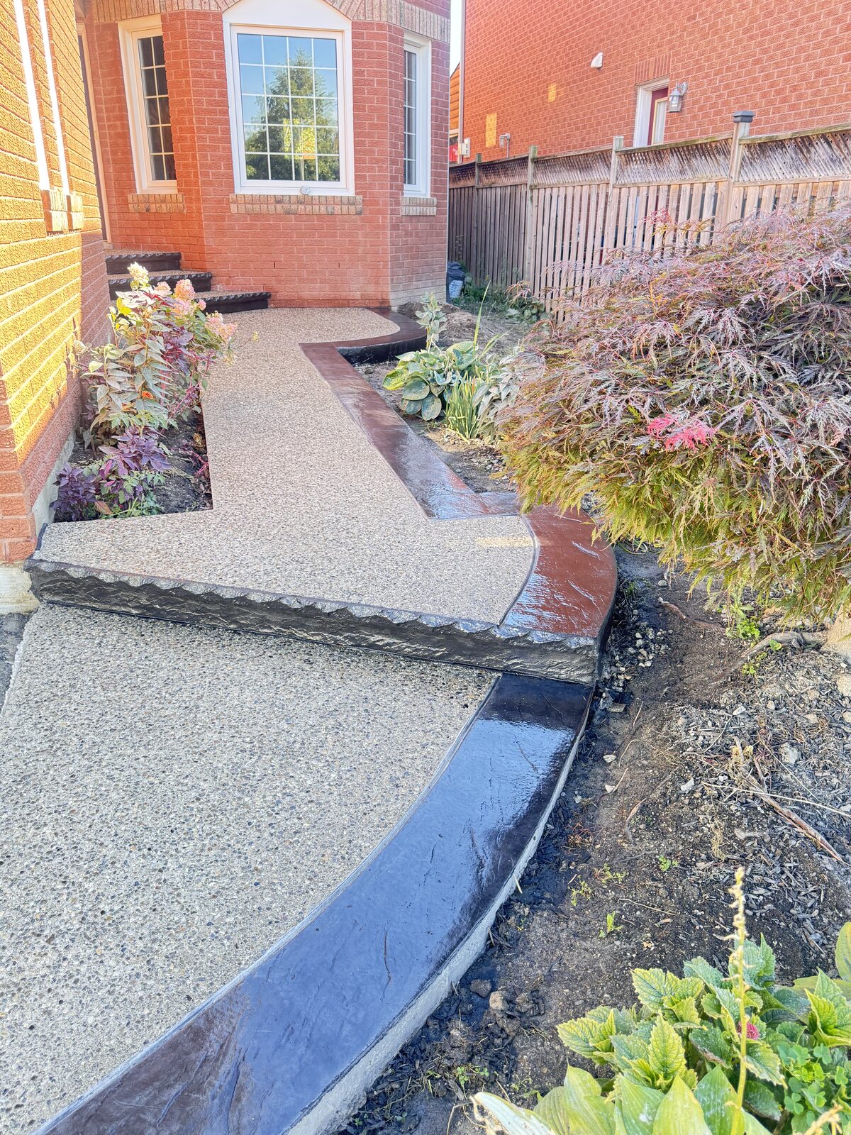 Exposed aggregate walkway with decorative stamped concrete borders