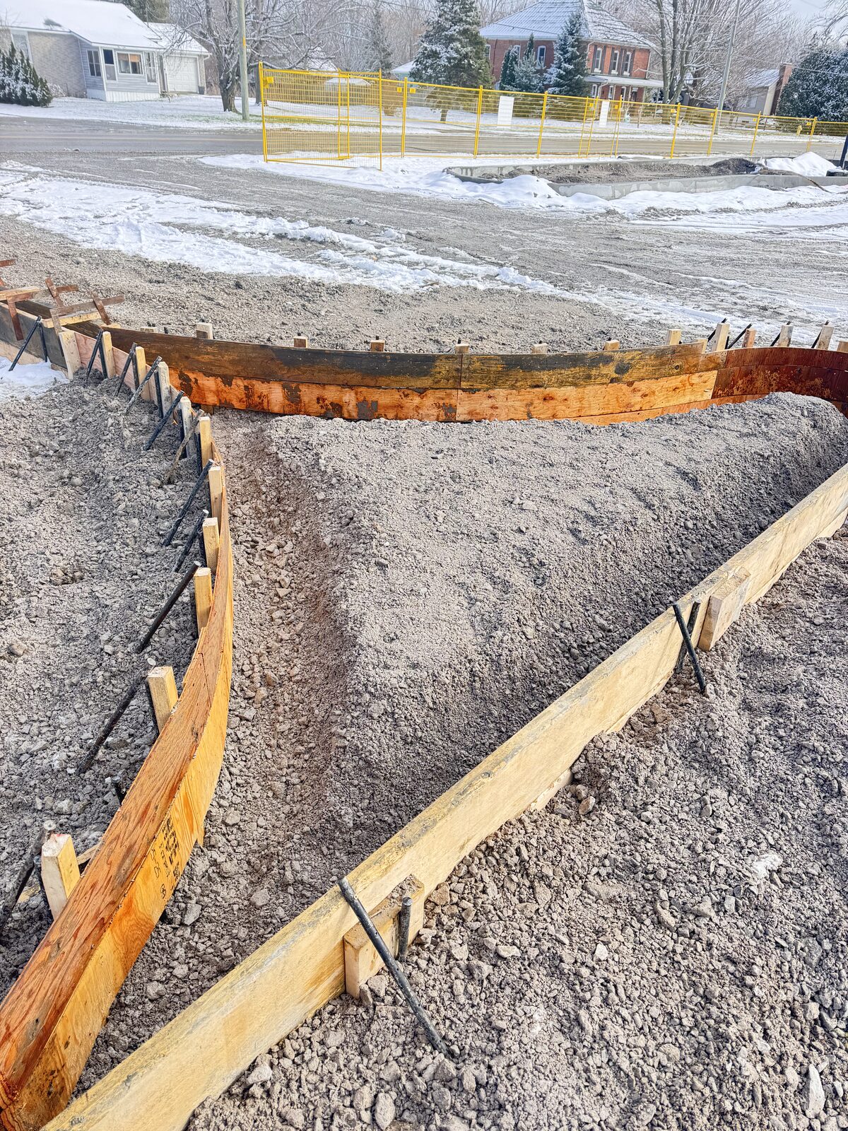 Concrete forms and rebar prepared for foundation in winter conditions