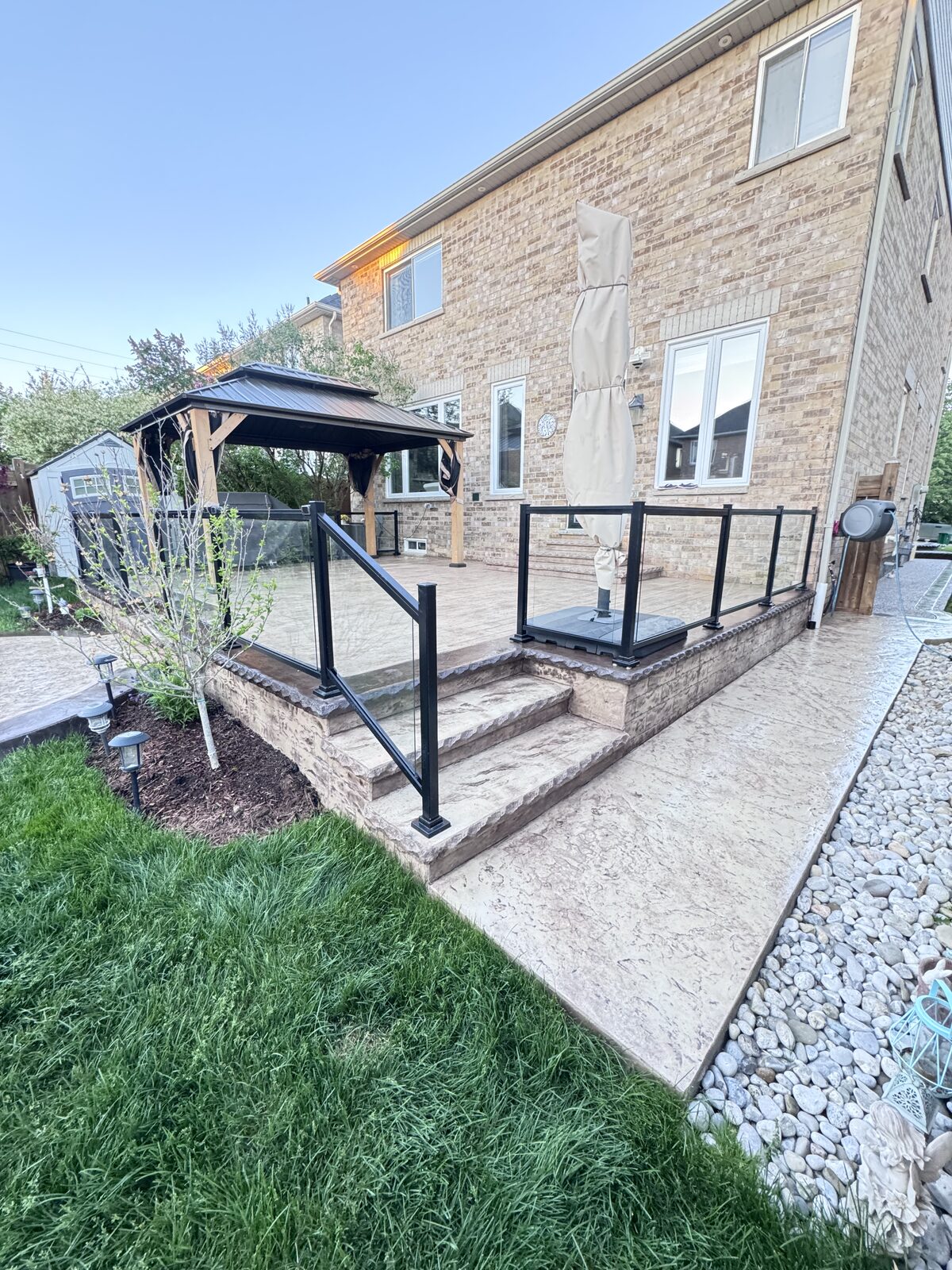 Stamped concrete patio with stairs, walkways and landscaping