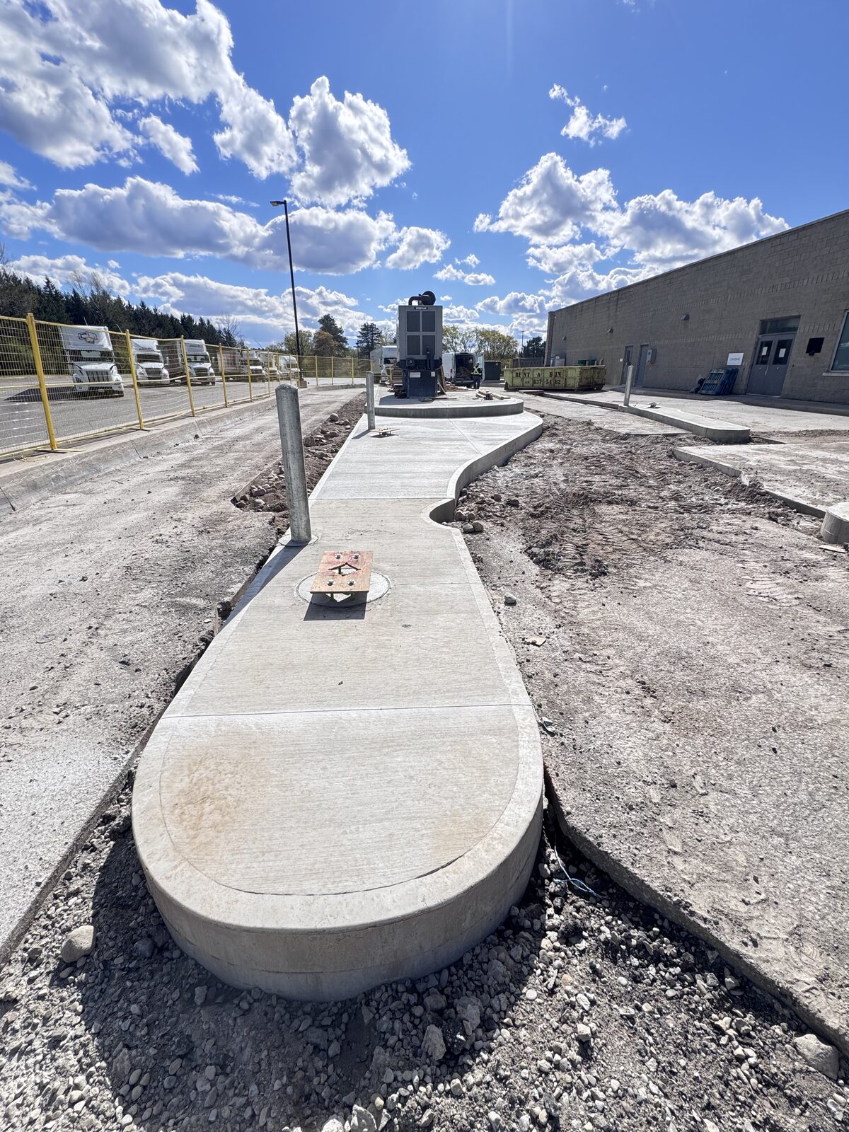 New curved concrete walkway around underground structure
