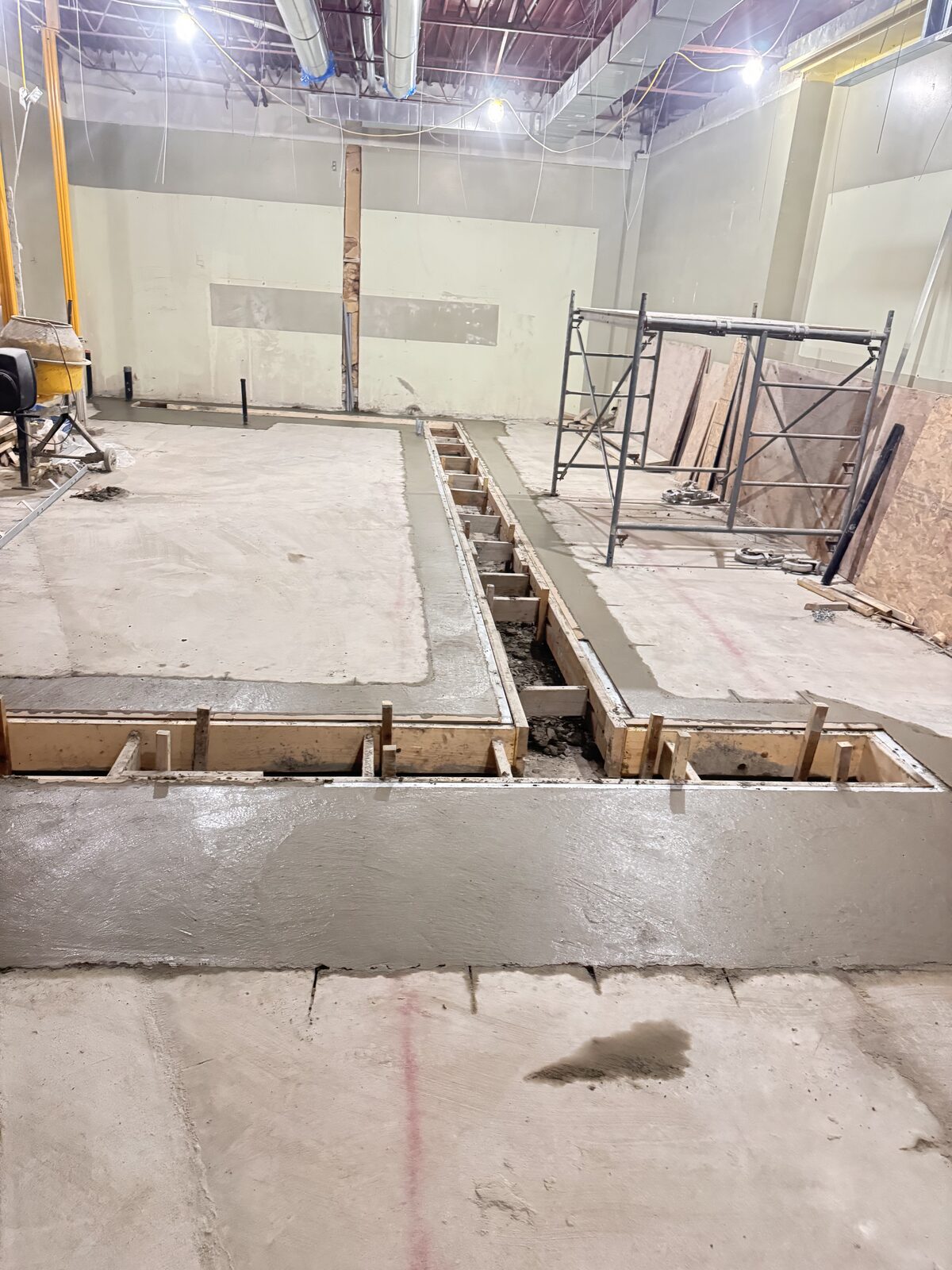 Concrete forms and fresh pour for an interior foundation.