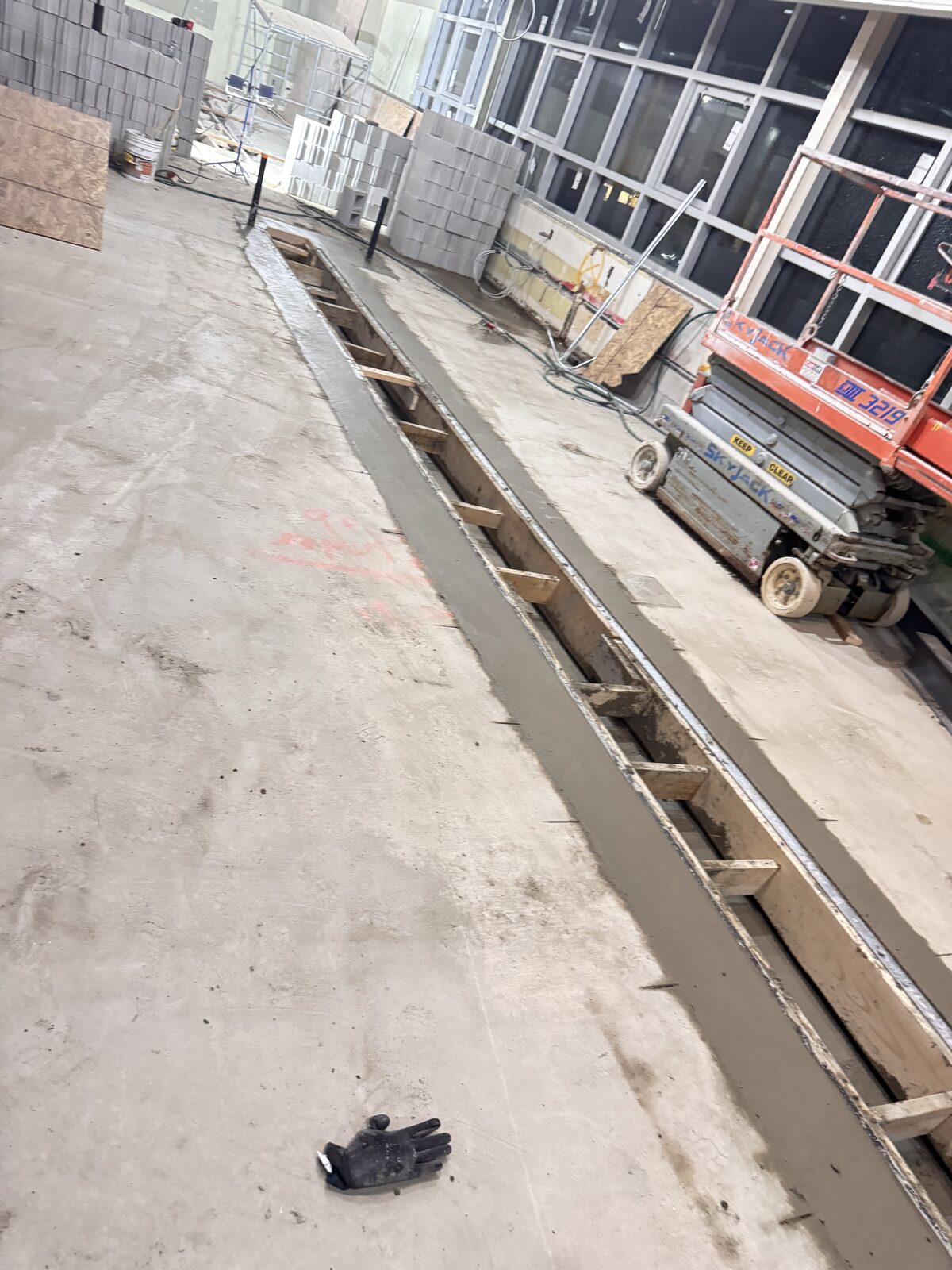 New concrete pour with wooden forms in a commercial construction setting